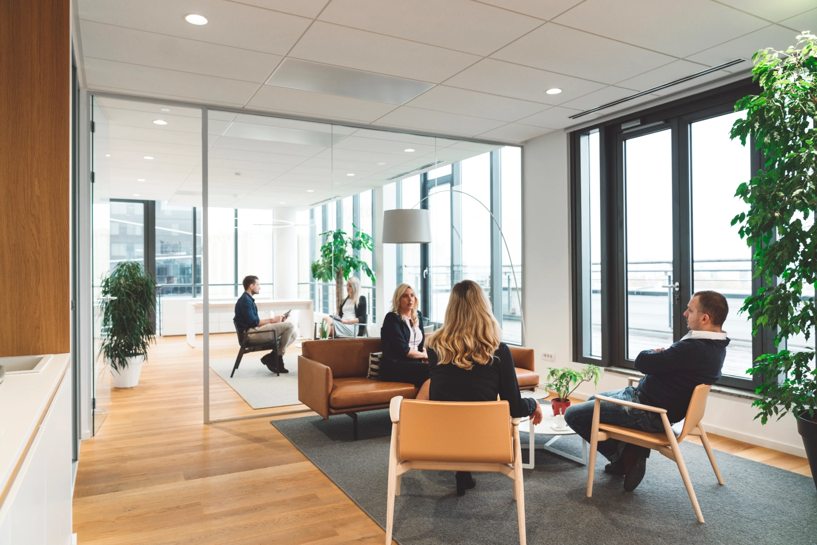 affluence mgt business people having multiple meetings in modern img